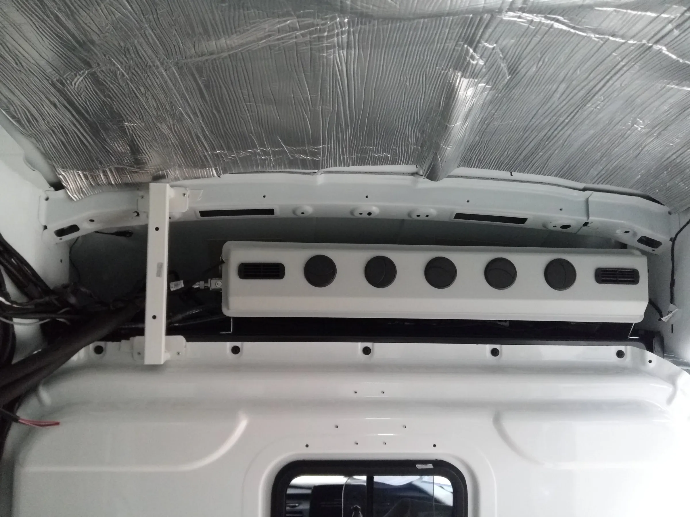 Ceiling console fitted above the cab partition during assembly