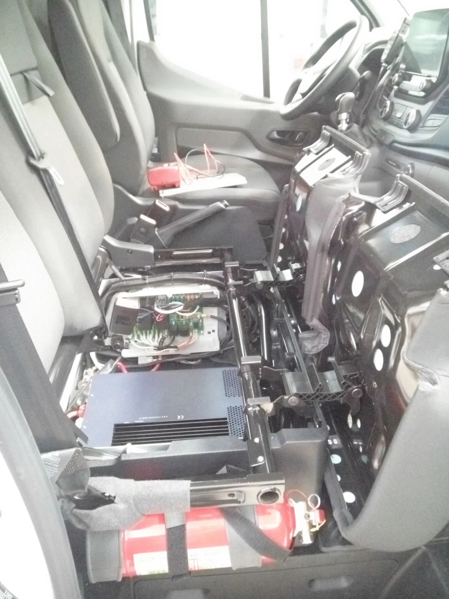 Electrical equipment installed under the cab seats during assembly