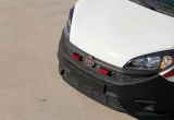 Red grille LED lights mounted on a vehicle front bumper