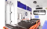 Patient compartment of the Land Cruiser ambulance with two oxygen cylinders, cabinets and stretcher